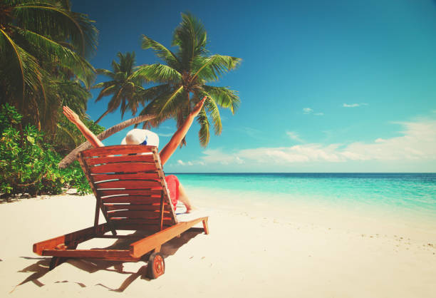 istock happy woman relax on tropical beach 882988302