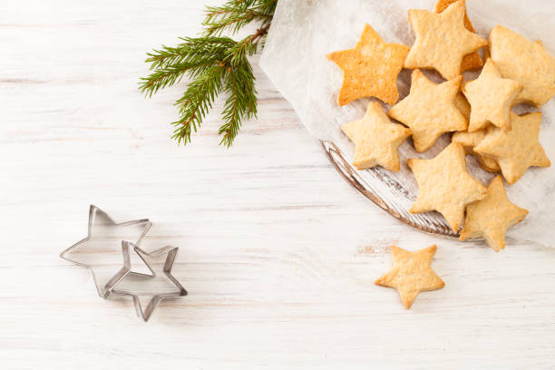 istock Fresh baked biscuits on the baking paper with fir branch on white 882988412