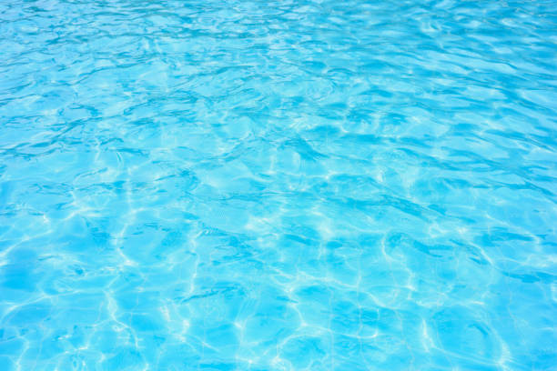 istock Ripple water in swimming pool with sun reflection 882993676