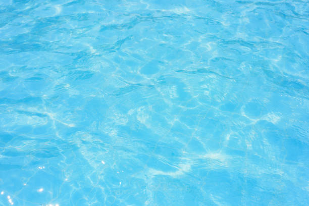 istock Ripple water in swimming pool with sun reflection 882998320
