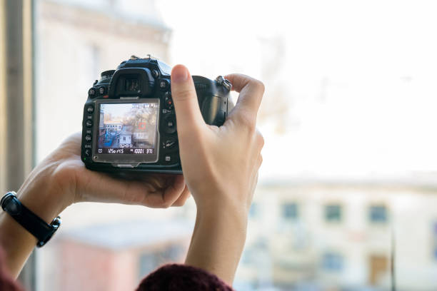 istock Close up female hands hold professional camera 883005052