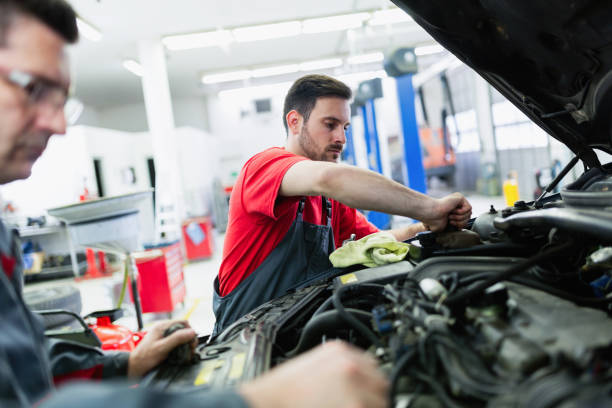 istock Car mechanics working at automotive service center 883005524