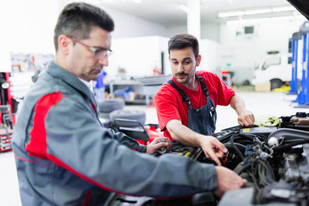 istock Car mechanics working at automotive service center 883005736