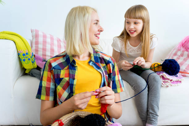 istock Girl knitting at home 883005808