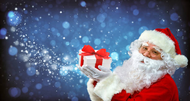 istock Santa Claus with magic light in his hands 883005884
