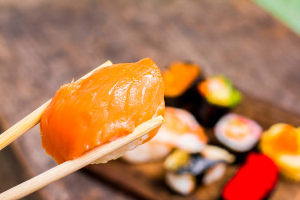 istock Top view,Sushi Set sashimi and sushi rolls served on wood slate.Copy space for your text. 883006014