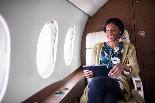 istock Woman in private jet airplane 883006806