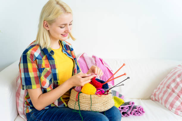 istock Girl knitting at home 883010014