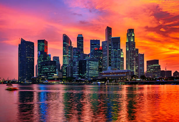 istock Colourful sunset over Singapore skyscrapers 883010408