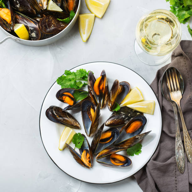 istock Shellfish mussels with white wine, seafood on a table 883019826
