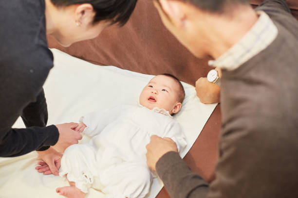 istock mother and father cheering up their baby 883020282