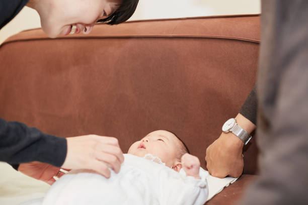 istock mother and father cheering up their baby 883020298
