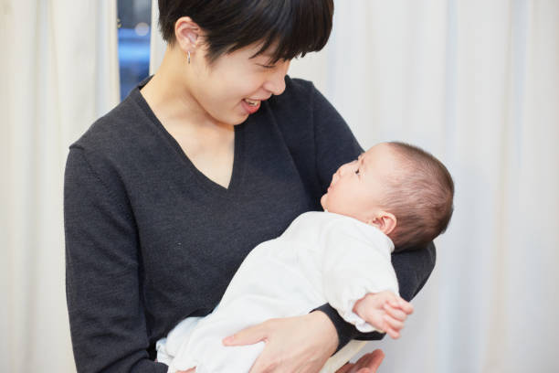 istock mother holding her baby to sleep 883020494