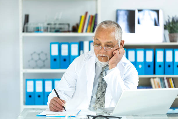 istock Medical specialist using laptop in cabinet 883027026