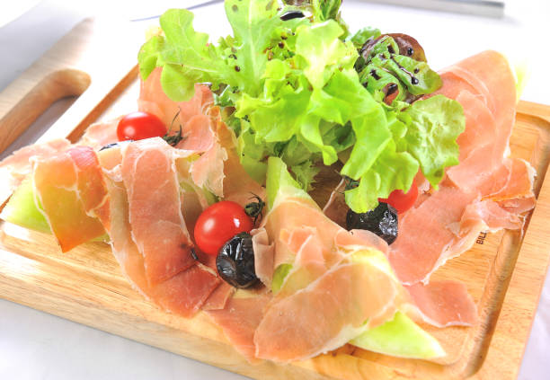 istock Slices of melon and prosciutto ham 883028210