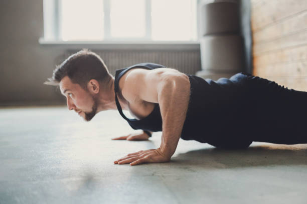istock Young man fitness workout, push ups or plank 883035238