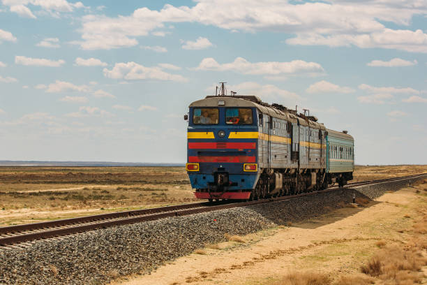 istock Locomotive train is passing through desert 883035242