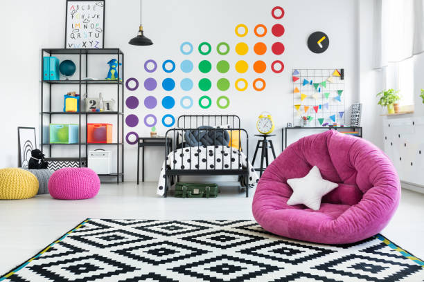 istock Pink pouf in colorful bedroom 883041324