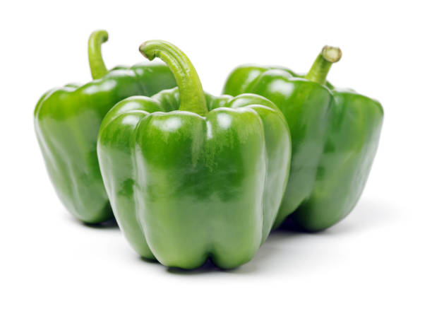 green bell peppers isolated on a plain white background