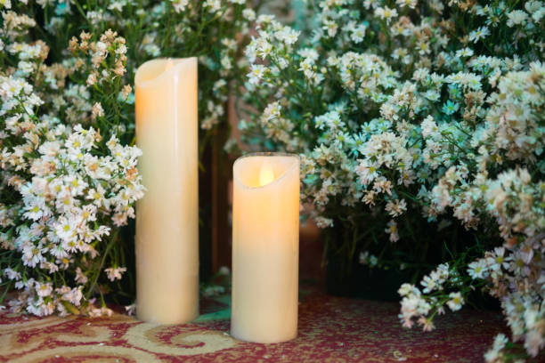 istock White burning candles for decorations with flower background, retro toned 883042200