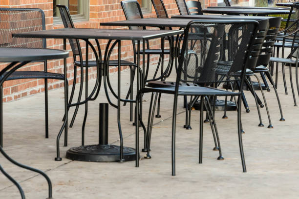 istock tables and chairs on the sidewalk on a cold morning 883042240