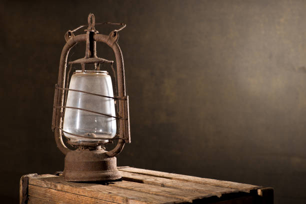 istock Old Rusty Lantern on the Wooden Desk in the Attic 883044890