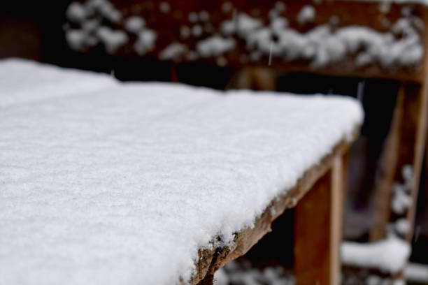 istock Snow on the wooden construction table 883045924