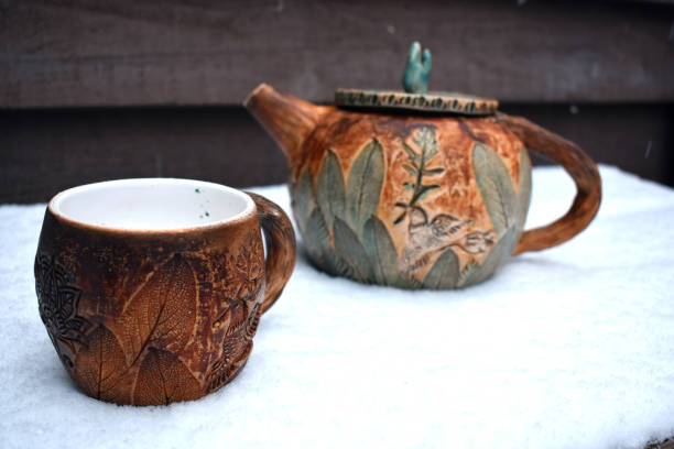 istock A teapot and a cup of tea steaming in the first snow 883048142
