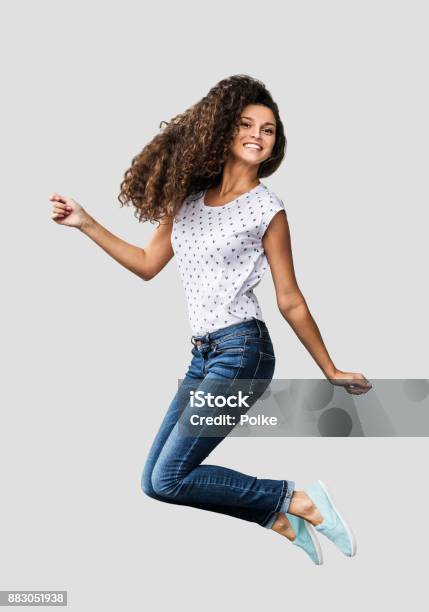 Beautiful Emotional Woman Is Jumping And Having Fun Stock Photo - Download Image Now