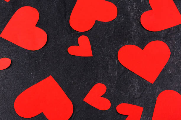 istock Hearts scattered close-up on a stone background 883057652