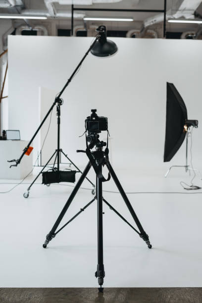 istock camera in photo studio with lighting equipment 883057704