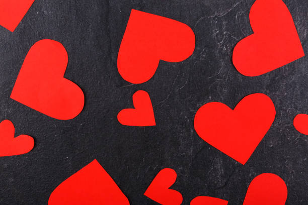 istock Hearts scattered close-up on a stone background. View from above 883057706