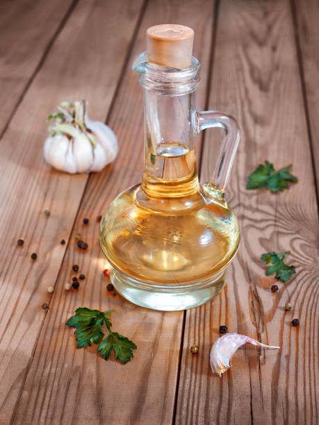 istock Vegetable oil in a decanter on a wooden background 883057874
