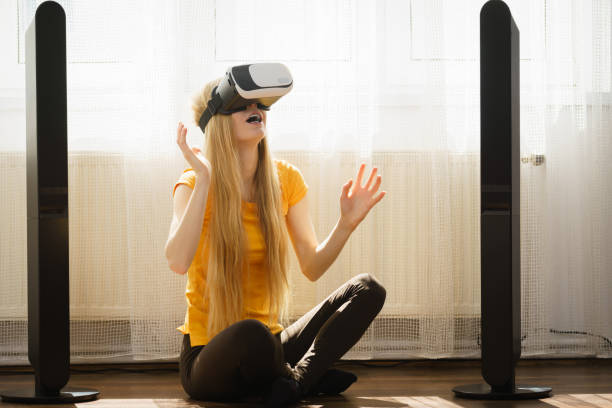 istock Girl wearing virtual reality goggles at home 883058028