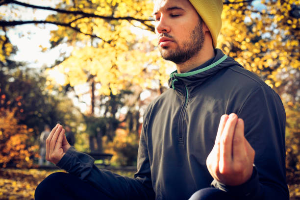 istock Man exercise yoga in nature. Eyes close. 883061318