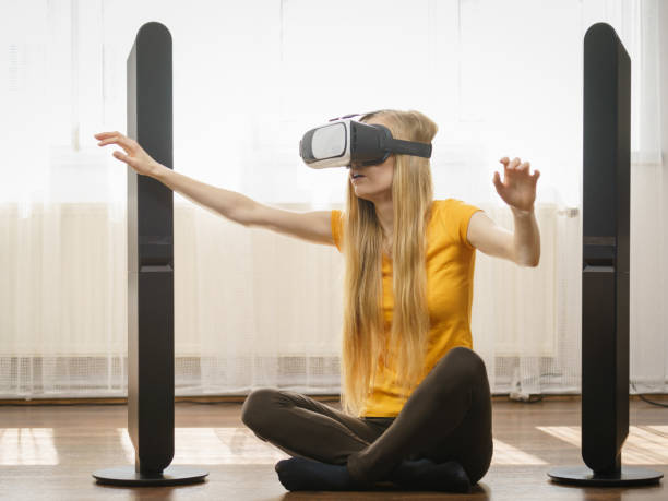 istock Girl wearing virtual reality goggles at home 883068824