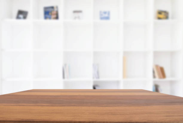 istock Empty wooden table and blur background of abstract in front of modern library or knowledge source can be used Mock up for display of product or for montage 883073800