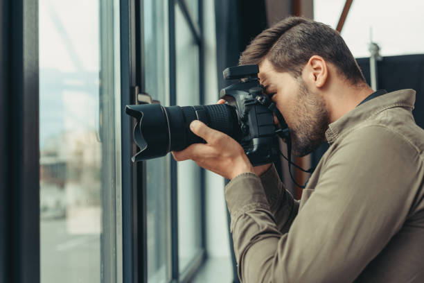 istock photographer with digital photo camera 883073908
