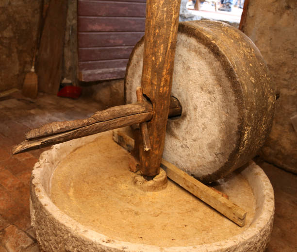 grinding wheel to grind the grain used by the ancient inhabitant very ancient grinding wheel to grind the grain used by the ancient inhabitants of Northern Italy old flour mill stock pictures, royalty-free photos & images