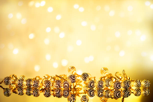 istock Christmas Gold background with garland lights 883087728
