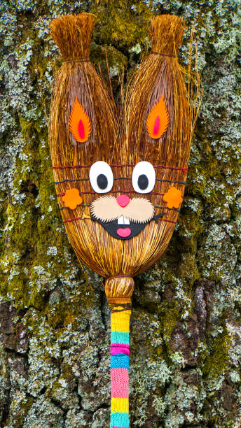 istock Happy smiling easter bunny before a brown trunk made of a broom 883091662