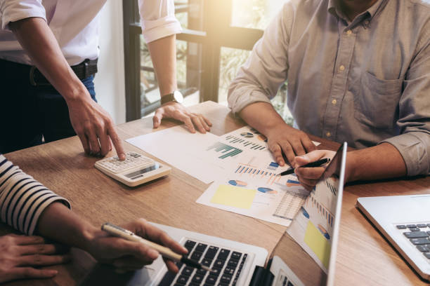 istock Business adviser analyzing financial with new startup finance project plan, co worker team discussing and brainstorming issues to achieve better results, working together, Group of meeting conference 883092206