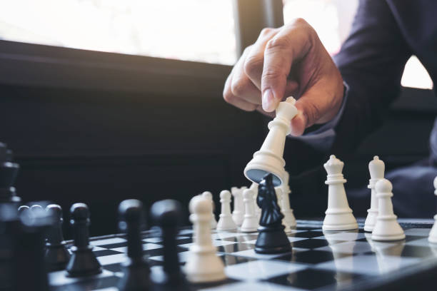 istock Close up of hands confident businessman colleagues playing chess game to development analysis new strategy plan, leader and teamwork concept for success. 883095880