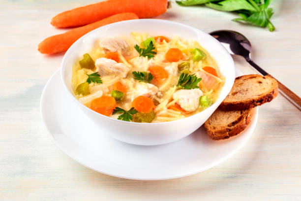 istock Chicken soup with noodles, bread, and copy space 883096622