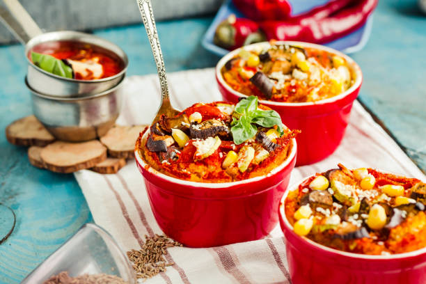 Portioned casserole"nfrom corn grits, eggplant and tomato sauce. Vegetarian gluten free dinner. stock photo