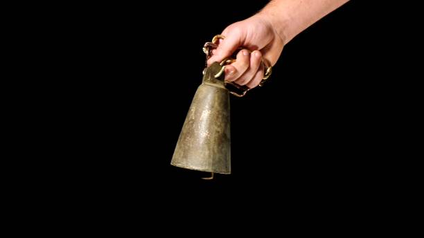 istock man with livestock bell in a hand 883102482