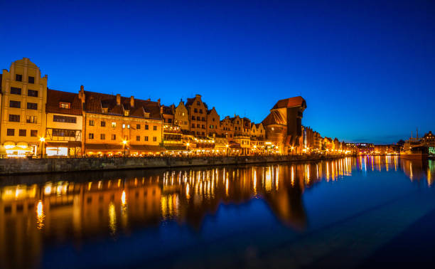 istock Gdansk at night with reflection in Motlawa river 883102614