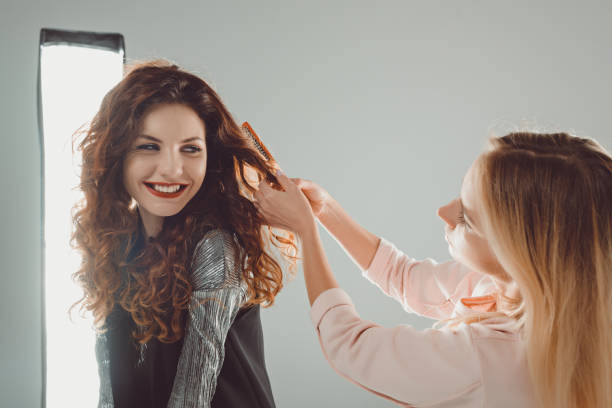 istock smiling model and hair stylist 883102724