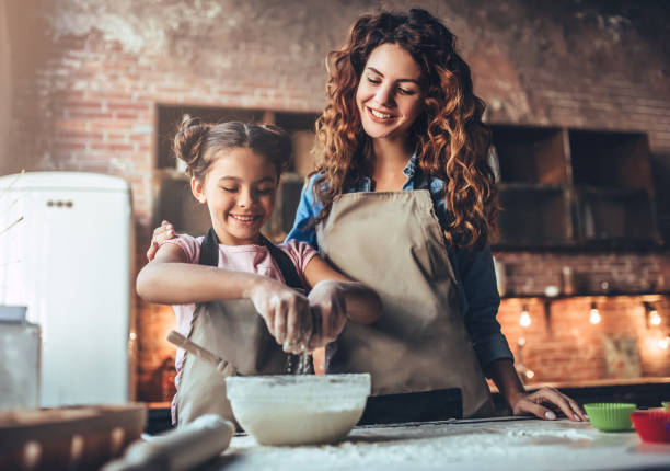 istock Mom with daughter on kitchen. 883103346