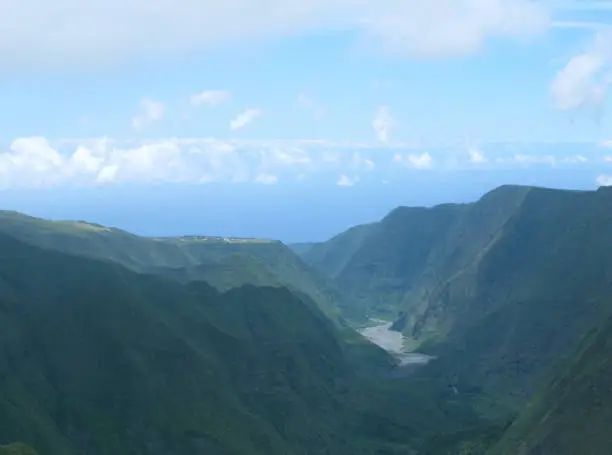 View over the deep caldera in which the Riviere des Remparts flows south from the slopes of the Piton des Songes to the Indian Ocean at Saint-Joseph